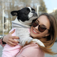 Girl Hugging Her Pet While Holding Him In Her Arms