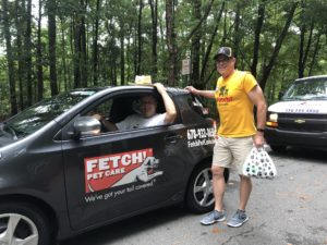 Mike McMackin, the Owner of Fetch! Pet Care of Roswell and East Cobb poses next to his Fetchmobile